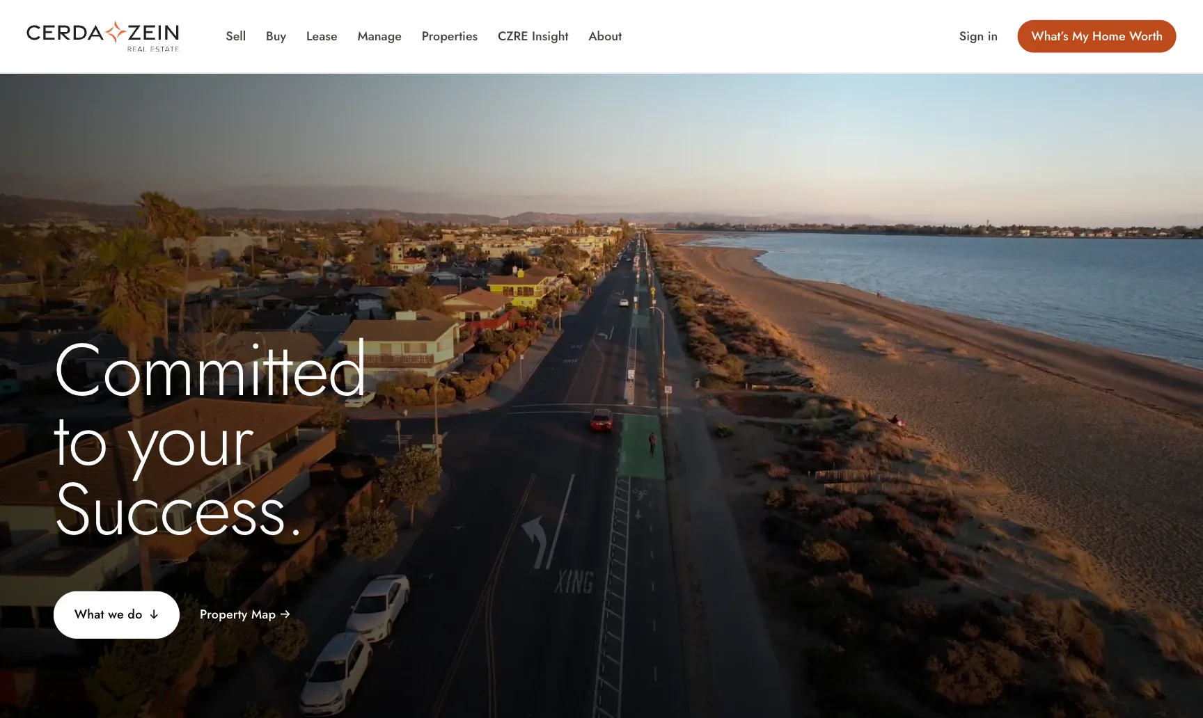 Cerda-Zein Real Estate website homepage on a MacBook